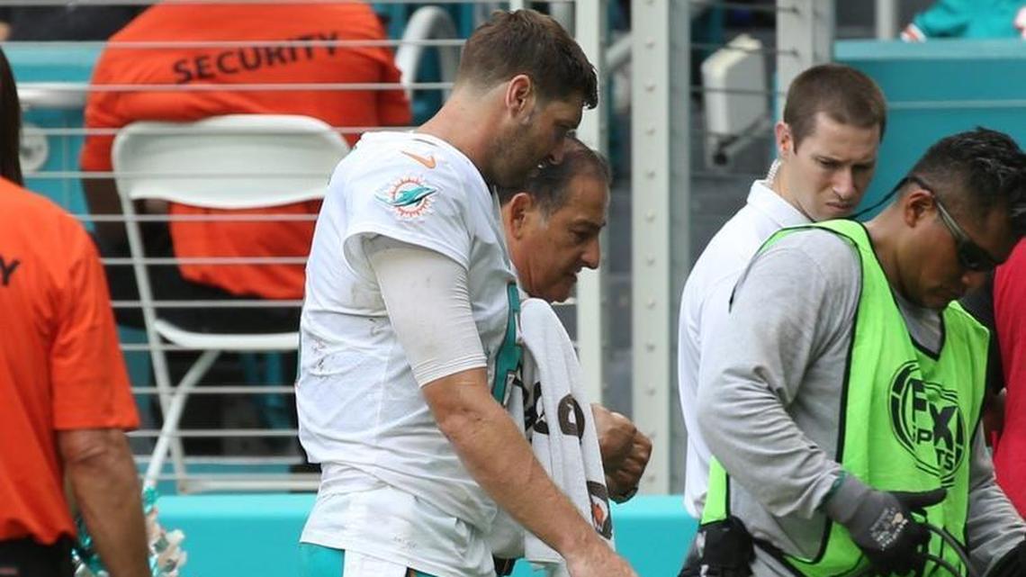 Jay Cutler walks to the Dolphins locker room after cracking multiple ribs Sunday.
