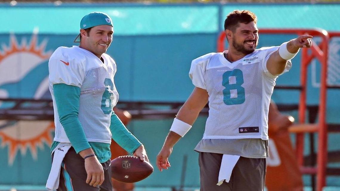 Miami Dolphins quarterbacks Jay Cutler (6) and Matt Moore (8) warm up during Dolphins training camp in Davie, Fla., August 8, 2017.