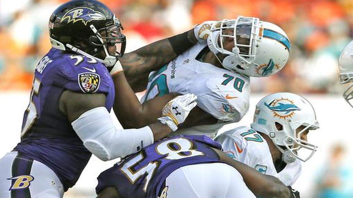 
Miami Dolphins quarterback Ryan Tannehill (17) is sacked by Baltimore Ravens outside linebacker Elvis Dumervil (58) in the fourth as the Miami Dolphins host the Baltimore Ravens at Sun Life Stadium in Miami Gardens on Sunday, Dec. 7, 2014
