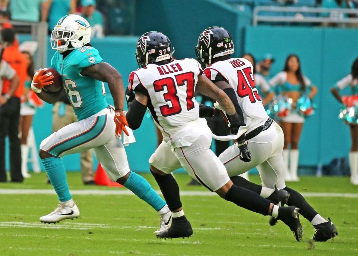 The Dolphins’ Damien Williams is chased by the Falcons’ Ricardo Allen (37) and Deion Jones (45) during the first quarter of Thursday night’s preseason opener at Hard Rock Stadium, which was still buzzing about the addition of Jay Cutler.
