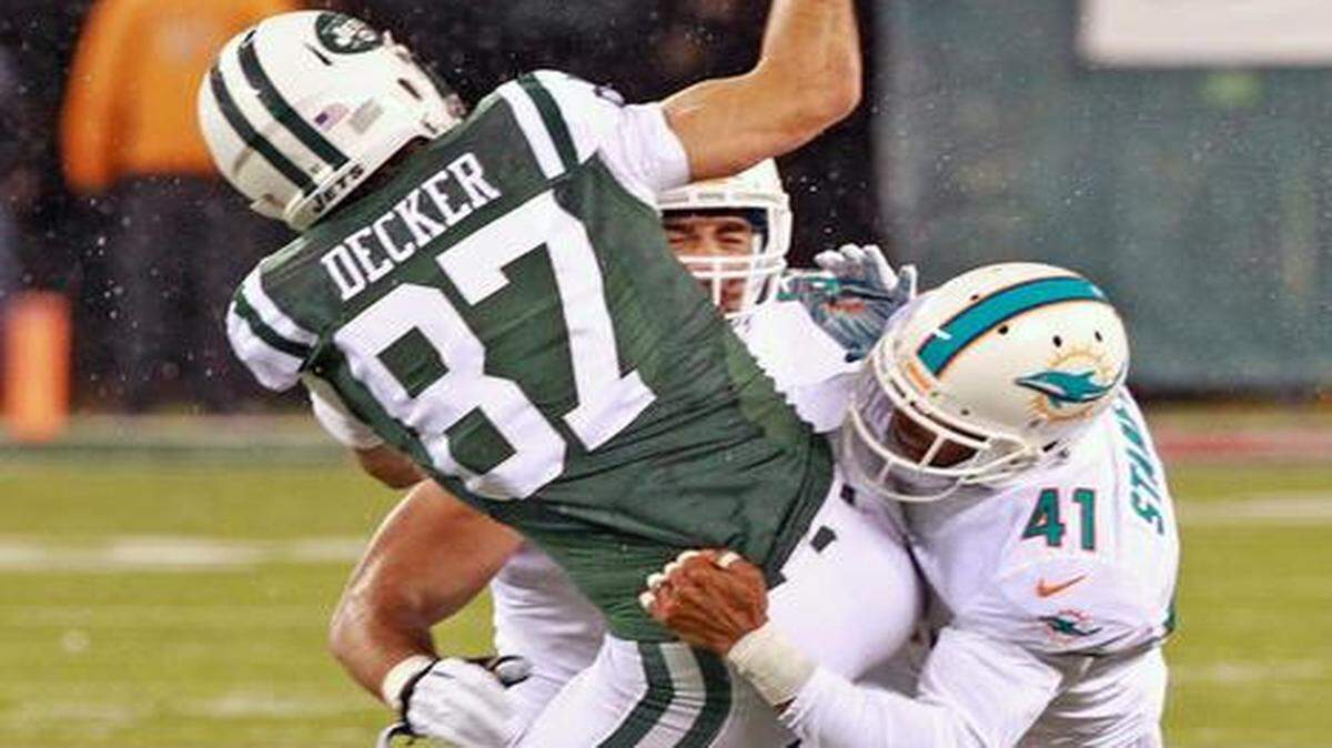 
Dolphins cornerback R.J. Stanford breaks up a pass to Jets receiver Eric Decker.
