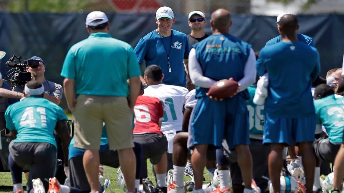 
Dolphins coach Joe Philbin, center, smiles as he talks to the players during the team’s rookie minicamp session Saturday in Davie.
