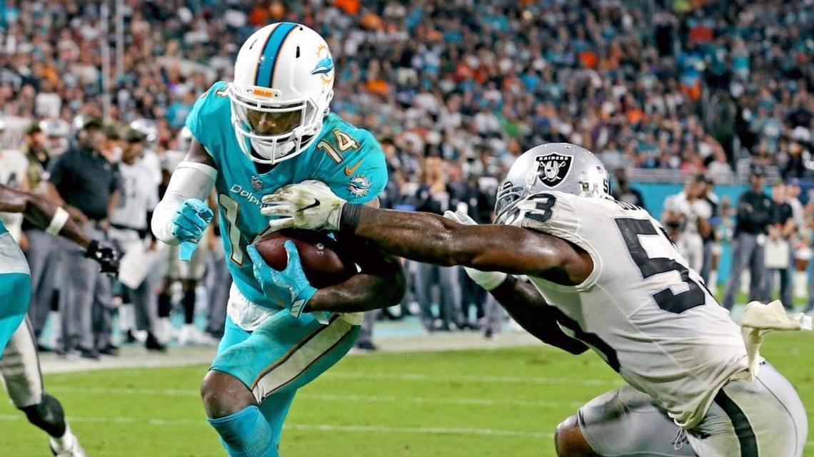 Miami Dolphins Jarvis Landry (14) scores a third quarter touchdown as Oakland Raiders NaVorro Bowman (53) fails to stop him at Hard Rock Stadium in Miami Gardens, Florida, November 5, 2017.