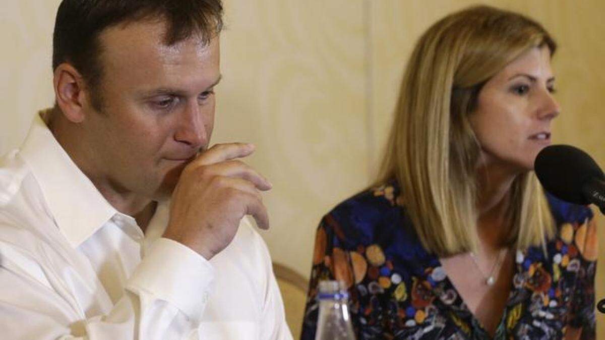 
Former Miami Dolphins fullback Rob Konrad, left, listens while his wife Tammy, right, responds to a question during a news conference Monday, Jan. 12, 2015, in Plantation, Fla.
