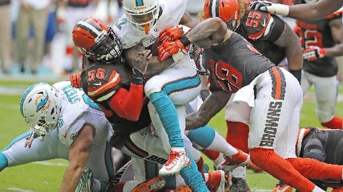 Isaiah Pead carries the football for the Dolphins in a game against Cleveland on Sept. 25.
