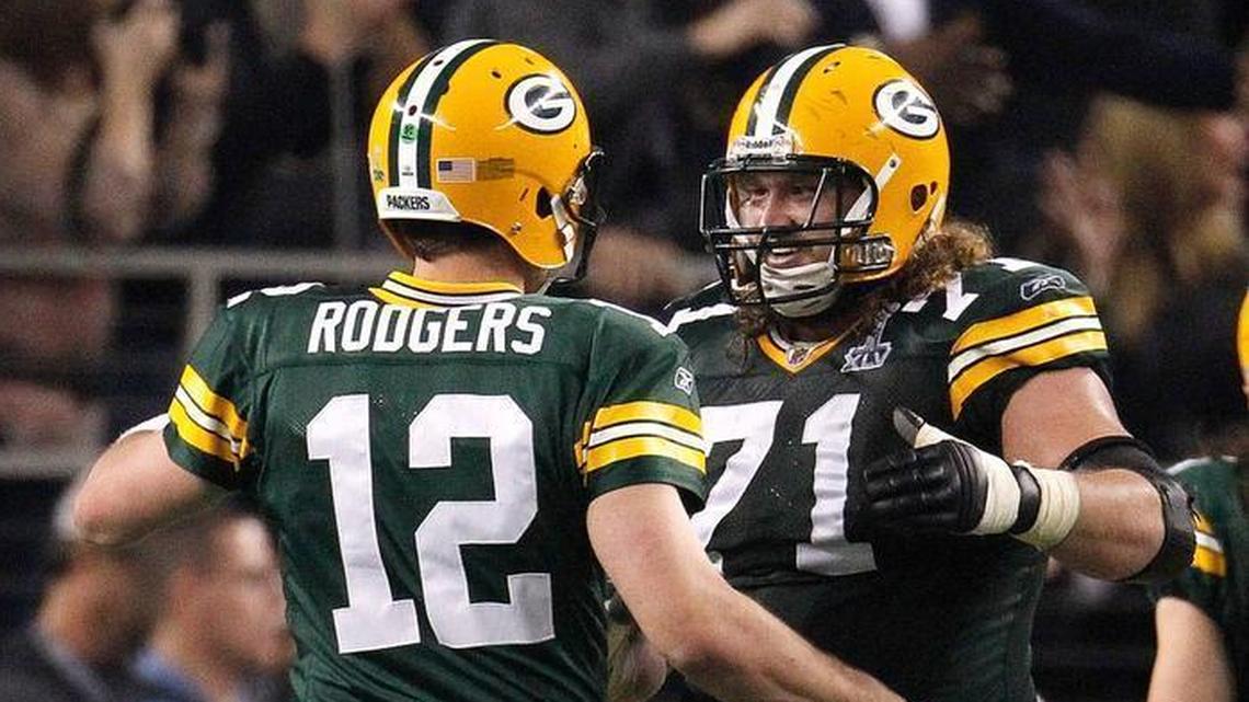 Green Bay Packers quarterback Aaron Rodgers (12) celebrates after a play with Green Bay Packers guard Josh Sitton (71) in third quarter action in Super Bowl XLV. Sitton signed a two-year deal with the Dolphins on Friday, March 16, 2018.