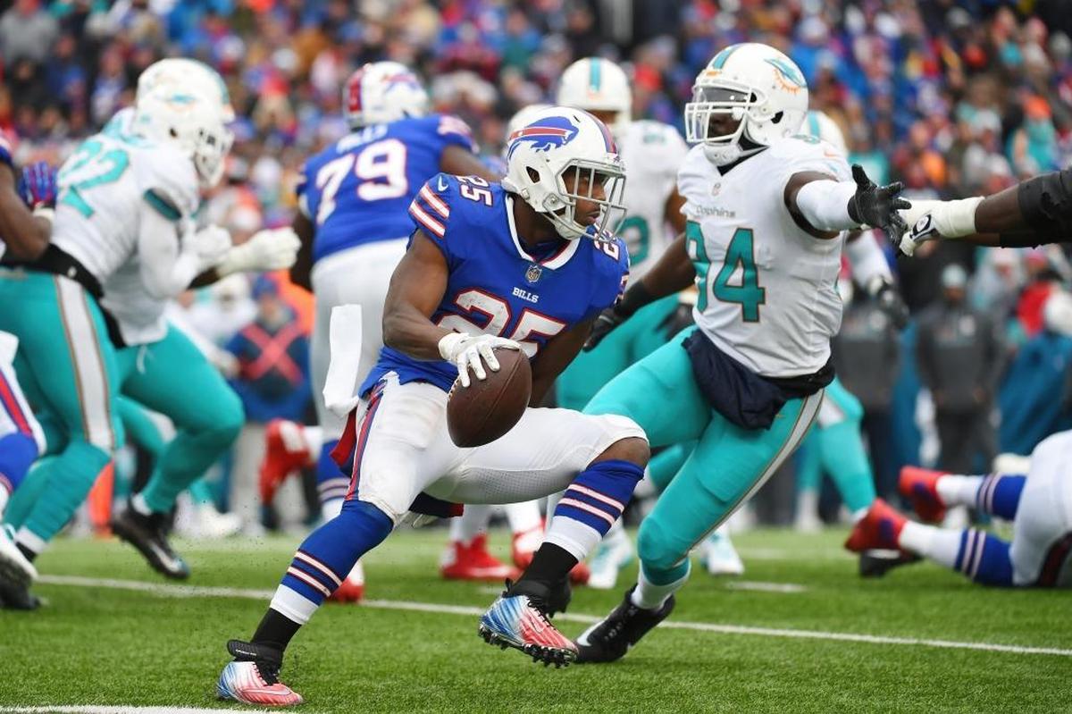Buffalo Bills running back LeSean McCoy (25) rushes past Miami Dolphins' Lawrence Timmons (94) during the first half of an NFL football game Sun., Dec. 17, 2017, in Orchard Park, N.Y.