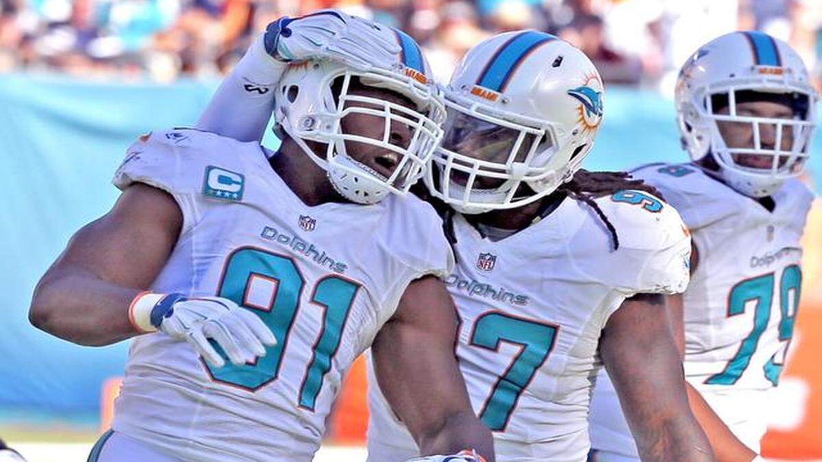 
Just win, baby: Cameron Wake (91), being congratulated by Kelvin Sheppard after a sack against the Chargers, is more concerned with winning than with the Dolphins defense’s impressive statistics.
