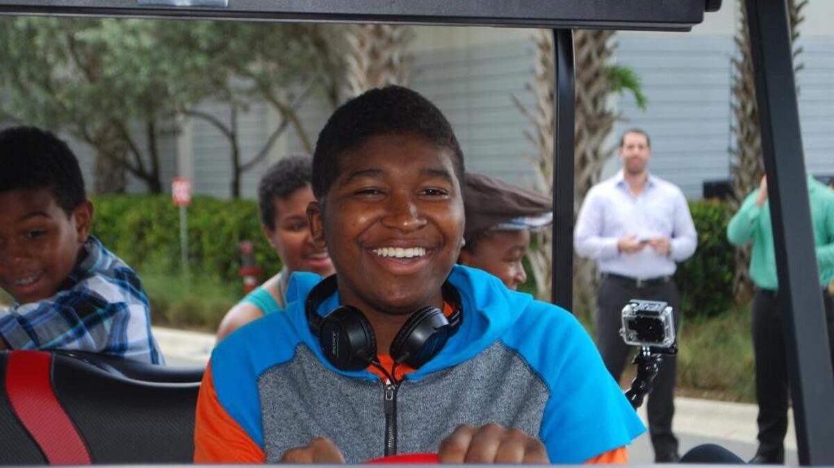 
Danny Adams, 14, rides his new golf cart for the first time Wednesday afternoon at Polen Capital’s Boca Raton office.
