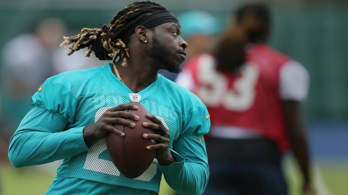 Miami Dolphins running back Jay Ajayi runs with the football during a training session at Allianz Park in London Friday.