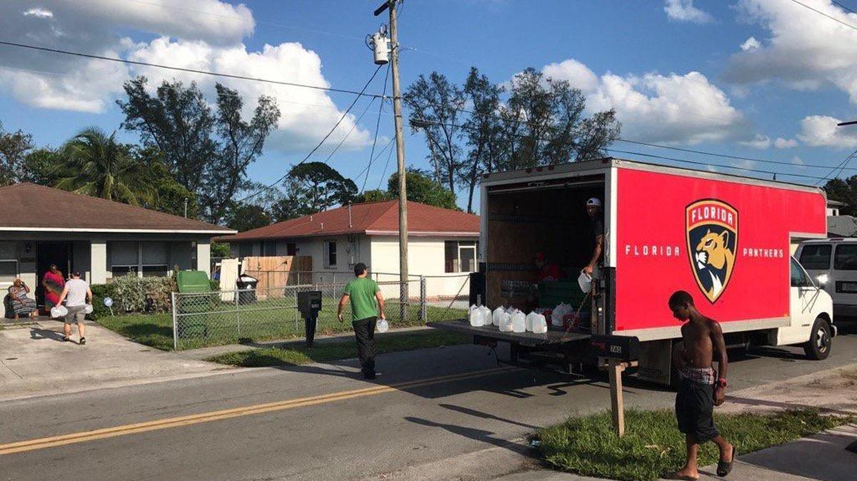 Members of the Florida Panthers organization deliver water in Fort Lauderdale following Hurricane Irma on Sept. 12, 2017.