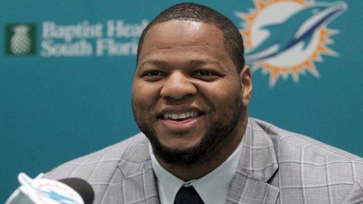 
New Miami Dolphin Ndamukong Suh is all smiles at his introductory press conference Wednesday, March 11, 2015 in Davie.
