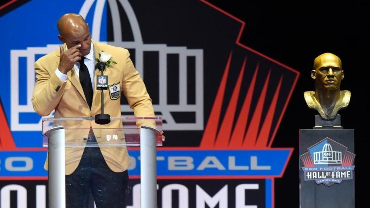 Jason Taylor wipes a tear from his eye as he delivers his speech at his induction, at the Pro Football Hall of Fame on Saturday, Aug. 5, 2017, in Canton, Ohio.