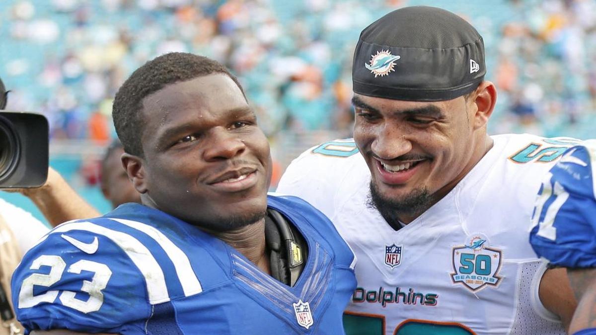 Former Coral Gables High and University of Miami star running back Frank Gore, left, who led the Colts to an 18-12 victory over the Dolphins in his hometown, laughs with Miami defensive end Olivier Vernon after Sunday’s game.