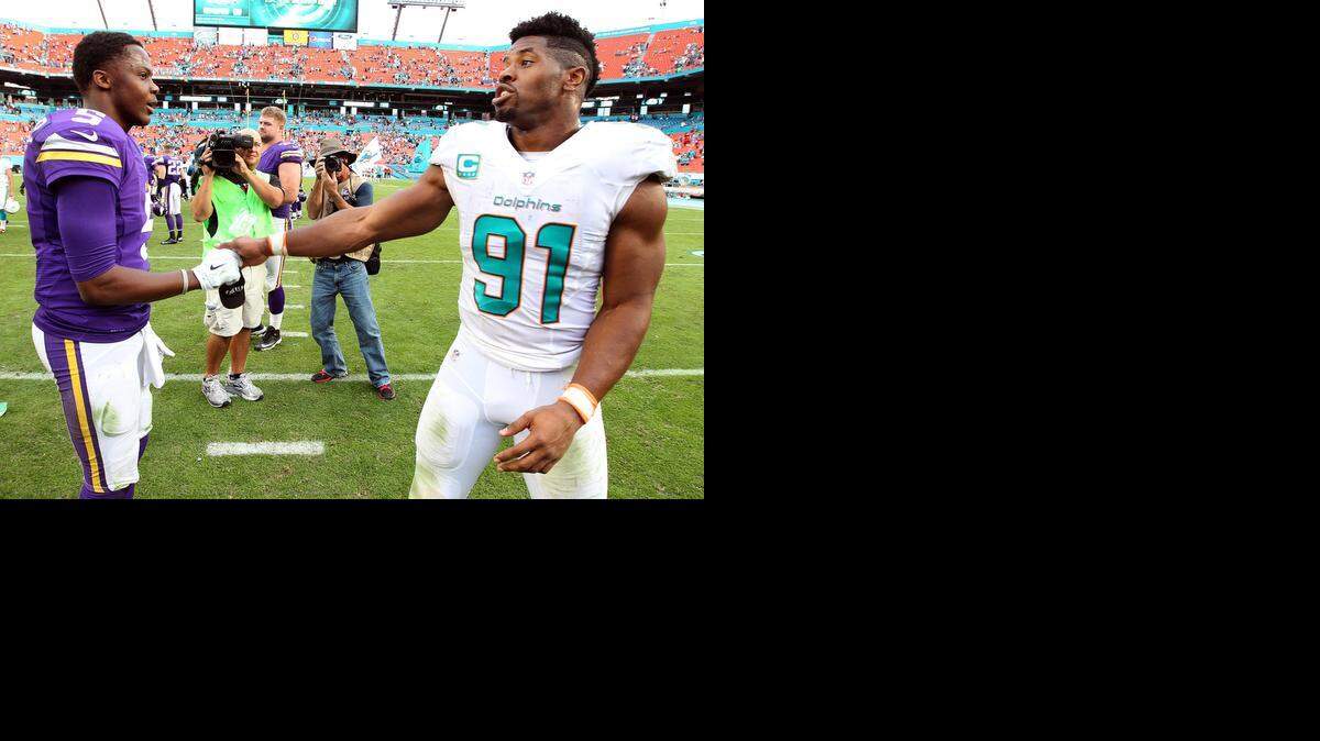
Miami Dolphins defensive end Cameron Wake talks with Minnesota Vikings quarterback Teddy Bridgewater after the game at Sun Life Stadium on Sunday, Dec. 21, 2014.
