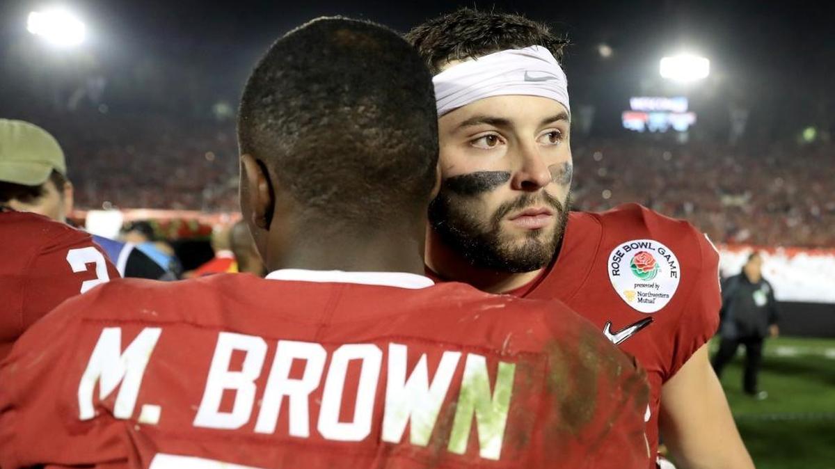 Baker Mayfield and Marquise Brown hug after losing to the Georgia Bulldogs in the 2018 College Football Playoff Semifinal Game.