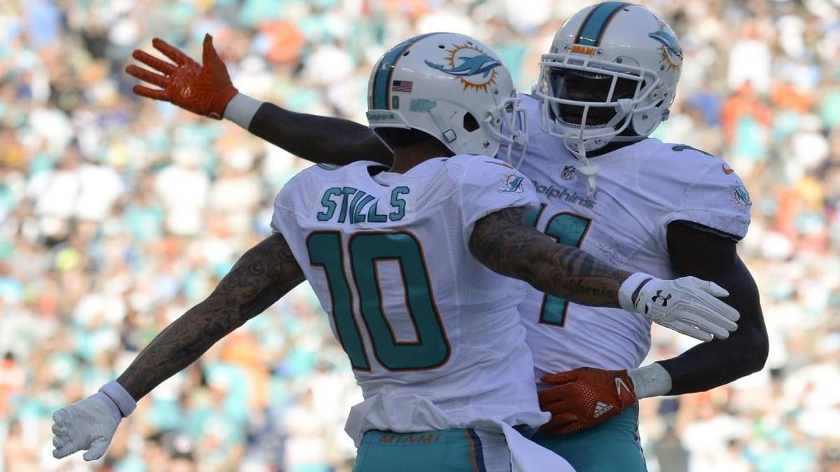 Miami Dolphins wide receiver Kenny Stills celebrates after scoring with DeVante Parker during the first half of an NFL football game against the San Diego Chargers in San Diego, Sun., Nov. 13, 2016.