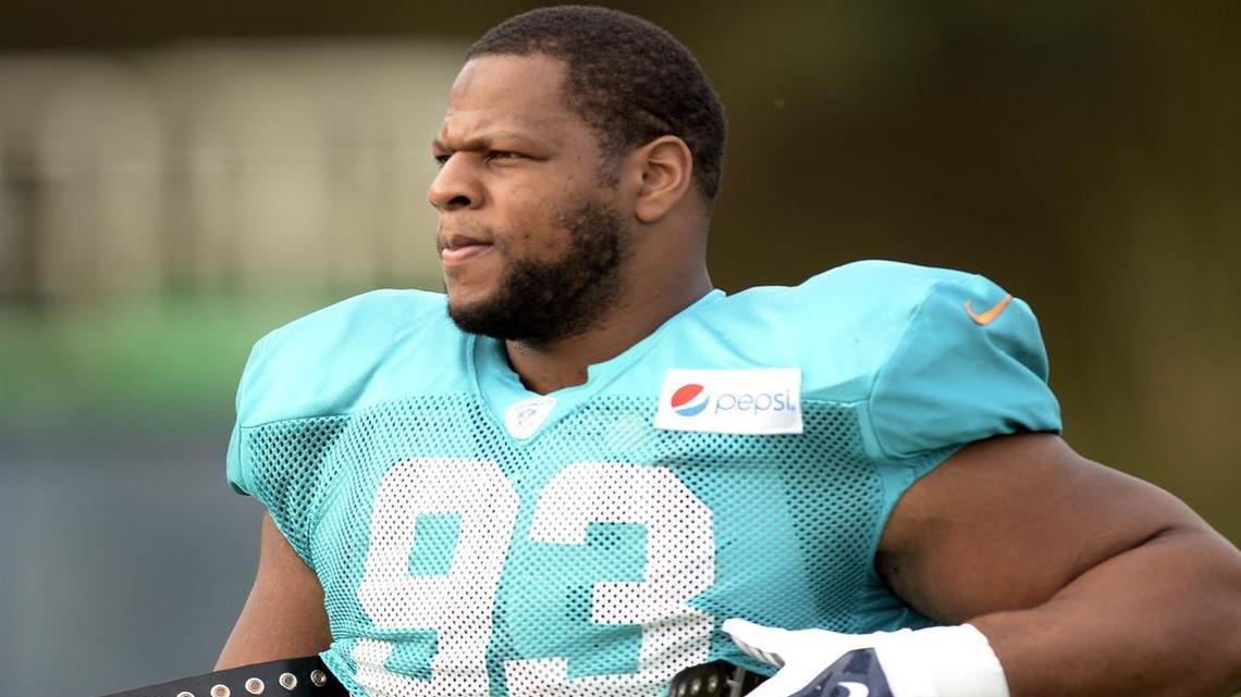 Miami Dolphins defensive end Ndamukong Suh walks onto the field prior to a scrimmage against the Carolina Panthers at Wofford College in Spartanburg, S.C., on Wednesday, Aug. 19, 2015.
