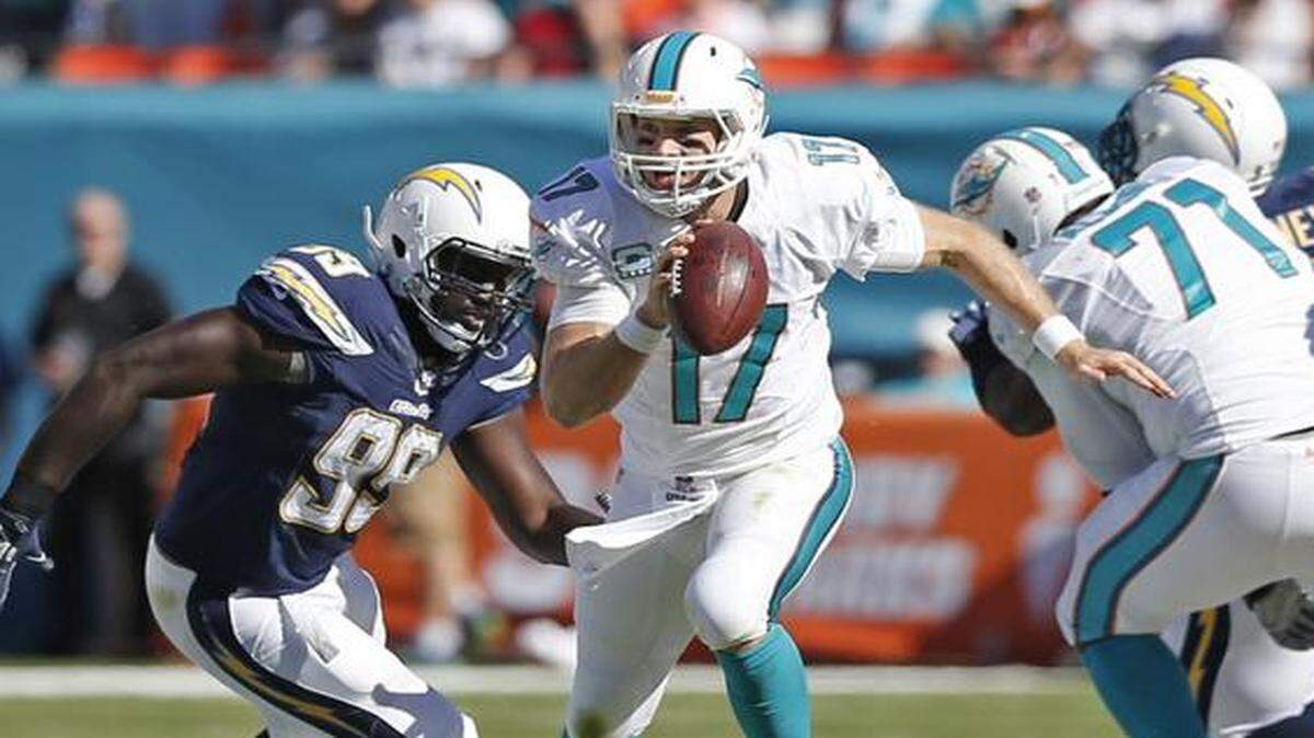 
Miami Dolphins quarterback Ryan Tannehill (17) scrambles out of the pocket for a first down in the second quarter against the San Diego Chargers at Sun Life Stadium on Sunday, Nov. 2, 2014.
