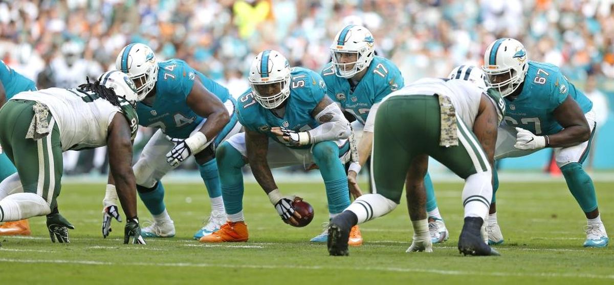 One of the keys to success for the Dolphins is the health of center Mike Pouncey (51) snaps to Miami Dolphins quarterback Ryan Tannehill (17) in the third quarter as the Miami Dolphins host the New York Jets at Hard Rock Stadium on Sunday, November 6, 2016.