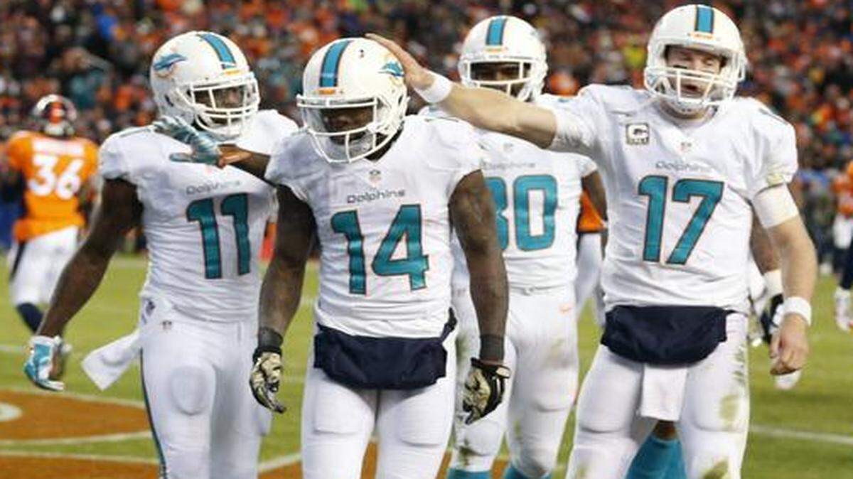 
Miami Dolphins quarterback Ryan Tannehill pats Jarvis Landry on the helmet after a third quarter touchdown as they play the Denver Broncos at Sports Authority Field at Mile High in Denver, Colorado, November 23, 2014.
