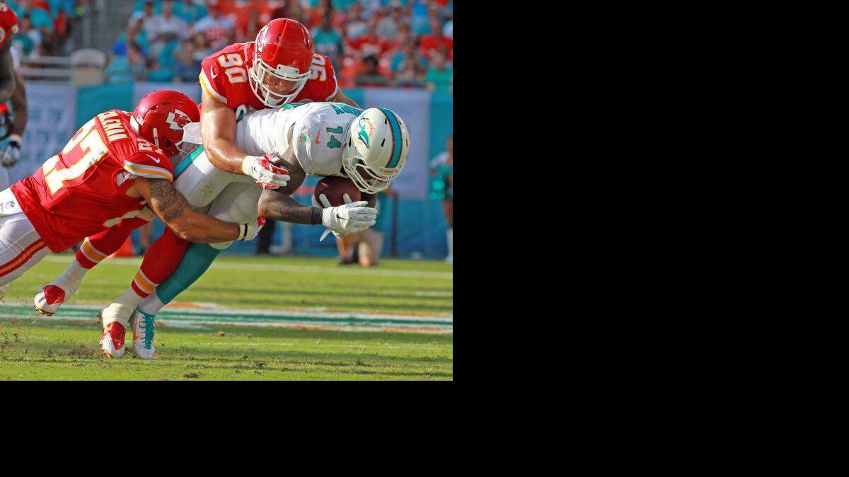 
Miami Dolphins wide receiver Jarvis Landry is tackled by Kansas City Chiefs defenders Kurt Coleman (27) and Josh Mauga (90) in the second quarter at Sun Life Stadium in Miami Gardens, Fla., on Sunday, Sept. 21, 2014. 
