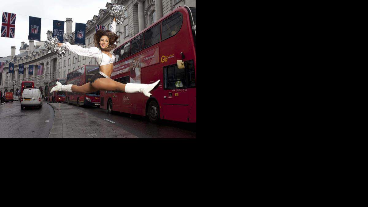 
Michelle, a cheerleader Raiderette from the Oakland Raiders, performs on Regent Street in London, Wednesday, Sept. 24, 2014 ahead of the NFL on Regent Street event taking place on Saturday. The event will consist of a range of activities including on-stage appearances and interviews with star players and head coaches from the Miami Dolphins and Oakland Raiders, and live music and entertainment.
