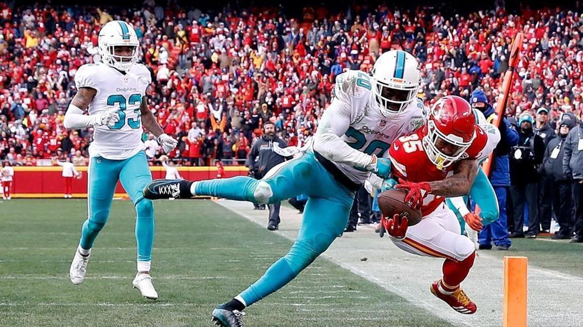 Safety Reshad Jones knocks running back Charcandrick West out of-bounds just before the end zone during the game at Arrowhead Stadium on December 24, 2017 in Kansas City, Mo.