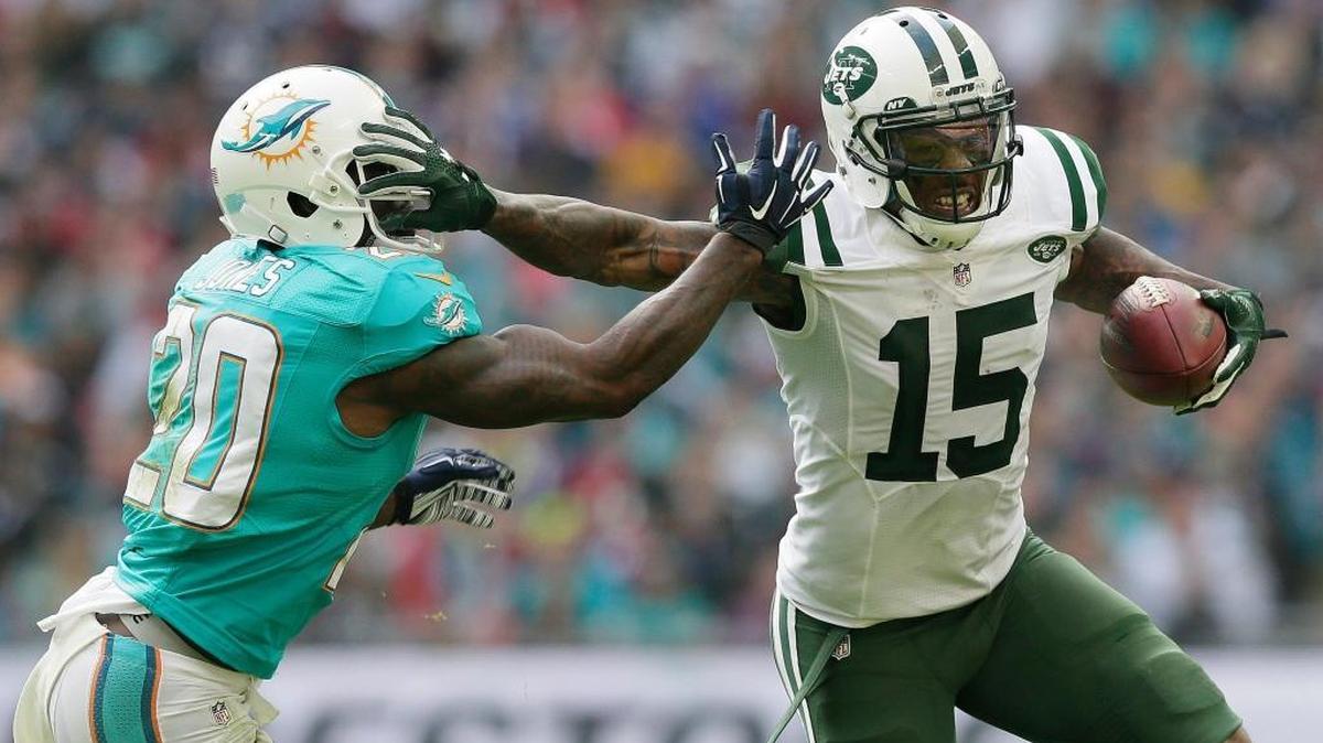 
New York Jets' Brandon Marshall, right, fends off Miami Dolphins' Reshad Jones during the NFL football game between the New York Jets and the Miami Dolphins and at Wembley stadium in London, Sunday, Oct. 4, 2015. 
