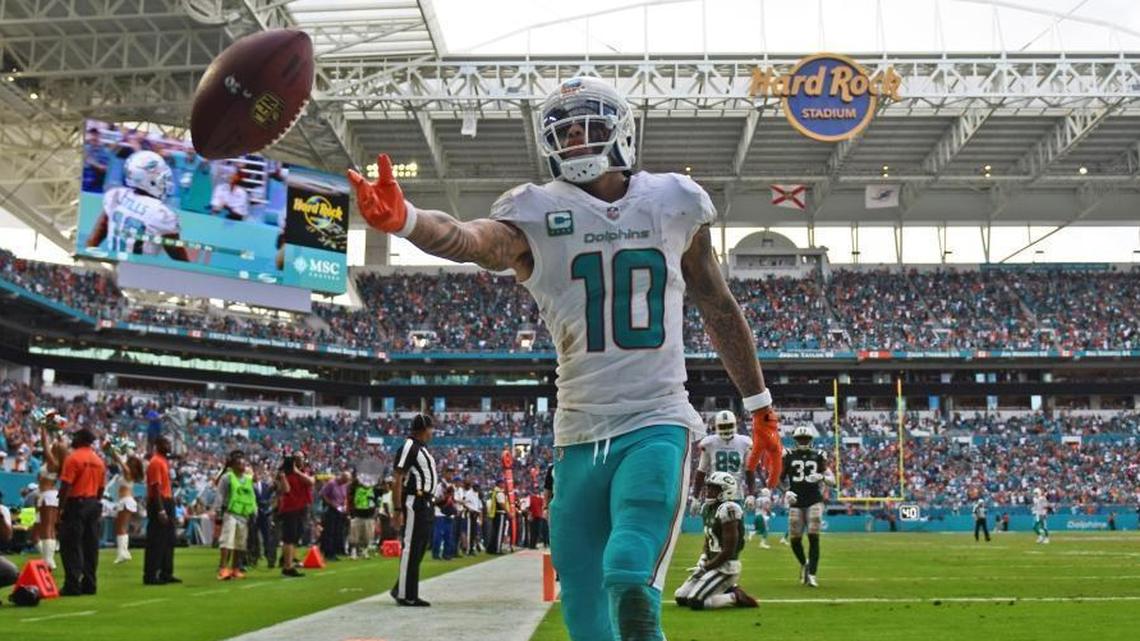 Miami Dolphins wide receiver Kenny Stills (10) celebrates a touchdown in the fourth quarter by tossing the ball to a fan against the New York Jets on Sunday, Oct. 22, 2017 at Hard Rock Stadium in Miami Gardens, Fla. (Jim Rassol/Sun Sentinel/TNS)