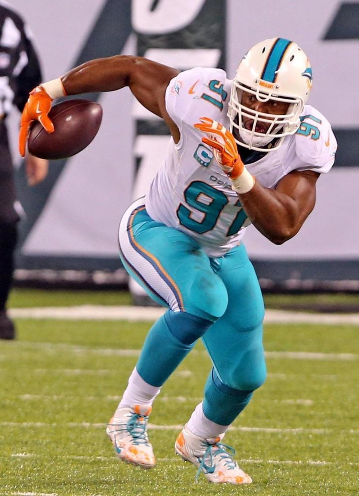 Miami Dolphins Cameron Wake intercepts the ball in the second quarter as they play the New York Jets at MetLife Stadium in East Rutherford, New Jersey, Dec. 17, 2016.