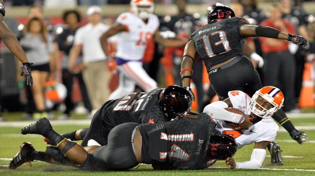 Louisville linebacker James Burgess (13), a graduate of Homestead High, wasn’t drafted primarily because of his size (5-11, 227).