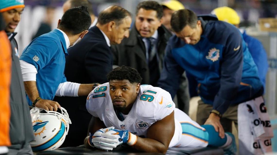 Miami Dolphins defensive end Cameron Wake (91) is checked on by doctors in the fourth quarter as the New England Patriots host the Miami Dolphins at Gillette Stadium in Foxborough, Massachusetts on Thursday, October 29, 2015.