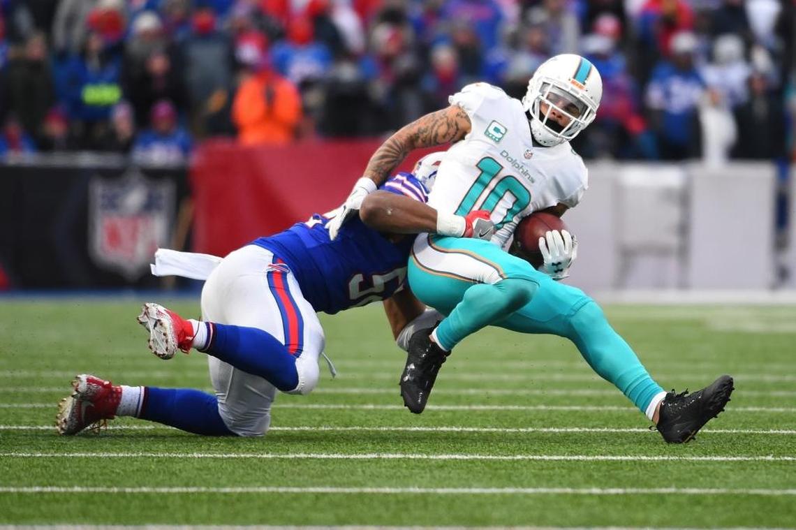 Buffalo Bills' Preston Brown (52) tackles Miami Dolphins' Kenny Stills (10) during the second half of an NFL football game Sun., Dec. 17, 2017, in Orchard Park, N.Y. The Bills won 24-16.