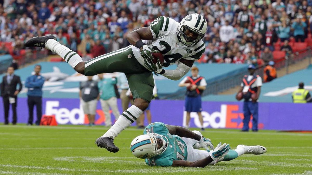 
New York Jets' Darrelle Revis makes an interception over Miami Dolphins' Jarvis Landry during the NFL football game between the New York Jets and the Miami Dolphins and at Wembley stadium in London, Sunday, Oct. 4, 2015.
