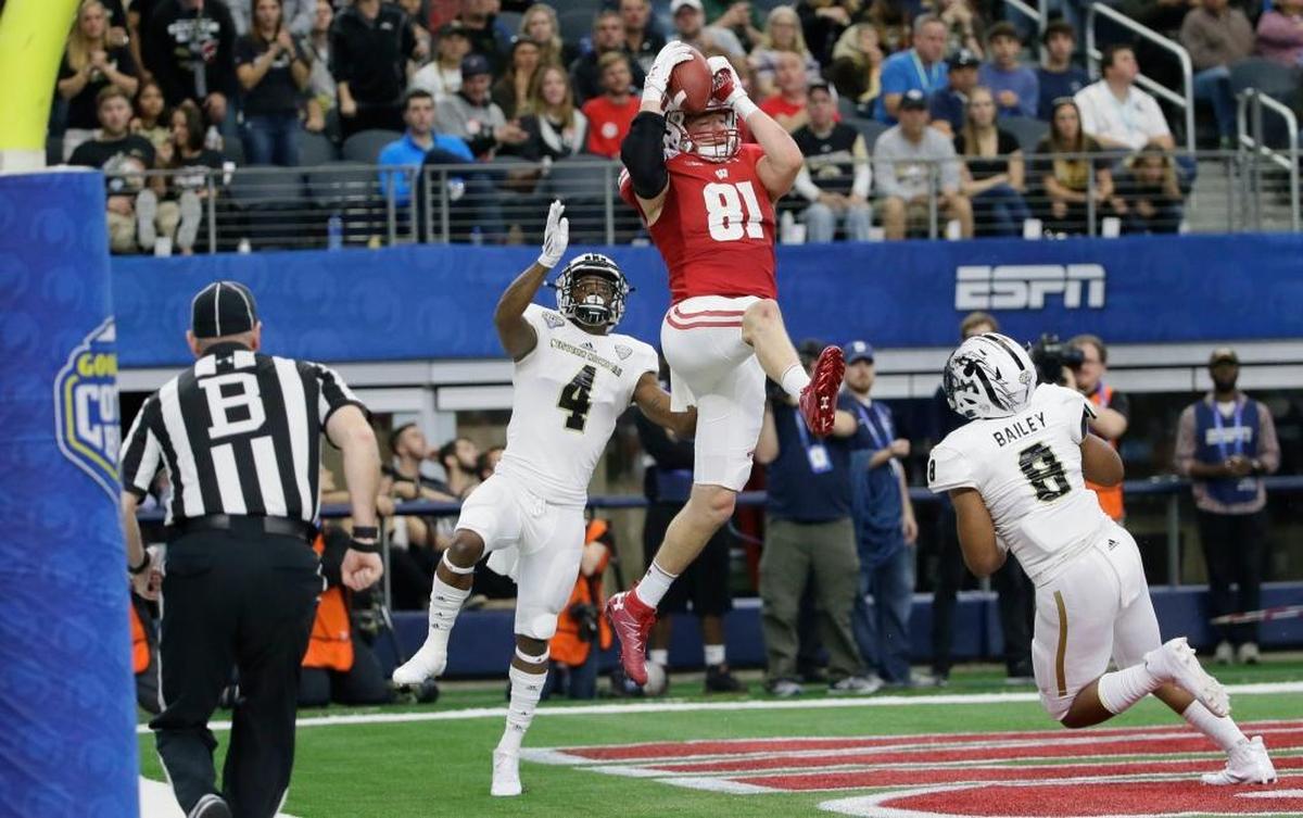 Wisconsin tight end Troy Fumagalli (81) catches a touchdown pass against Western Michigan defenders Darius Phillips (4) and Caleb Bailey (8) during the fourth quarter of the Cotton Bowl NCAA college football game Mon., Jan. 2, 2017, in Arlington, Texas.
