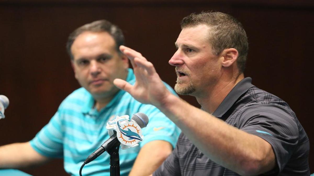 Dan Campbell, right, speaking to the media on Monday when he was named Dolphins interim coach, is the complete opposite of former coach Joe Philbin.