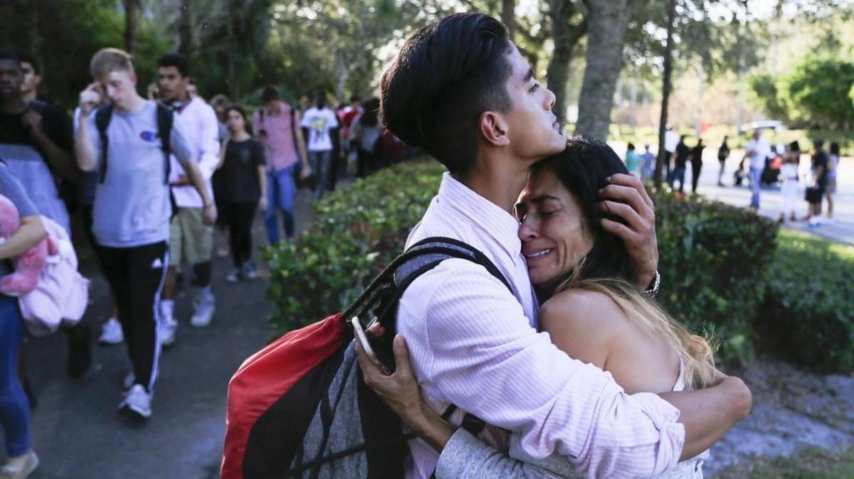 After a gunman opens fire on campus, Jorge Zapata, 16, a sophomore, hugs his mother, Lavinia Zapata, outside Marjory Stoneman Douglas High School on Wednesday, Feb. 14, 2018.