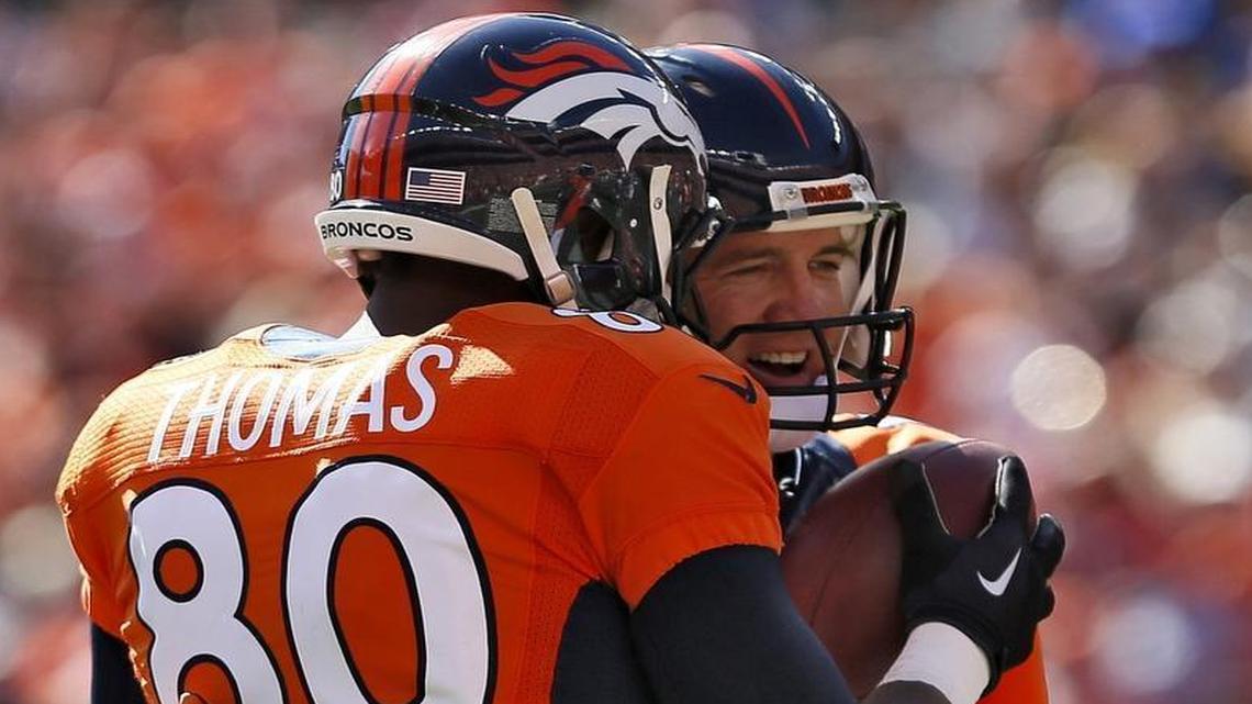 Denver Broncos quarterback Peyton Manning (18) hugs teammate Julius Thomas (80) after throwing his 500th career touchdown on Sunday, Oct. 5, 2014.