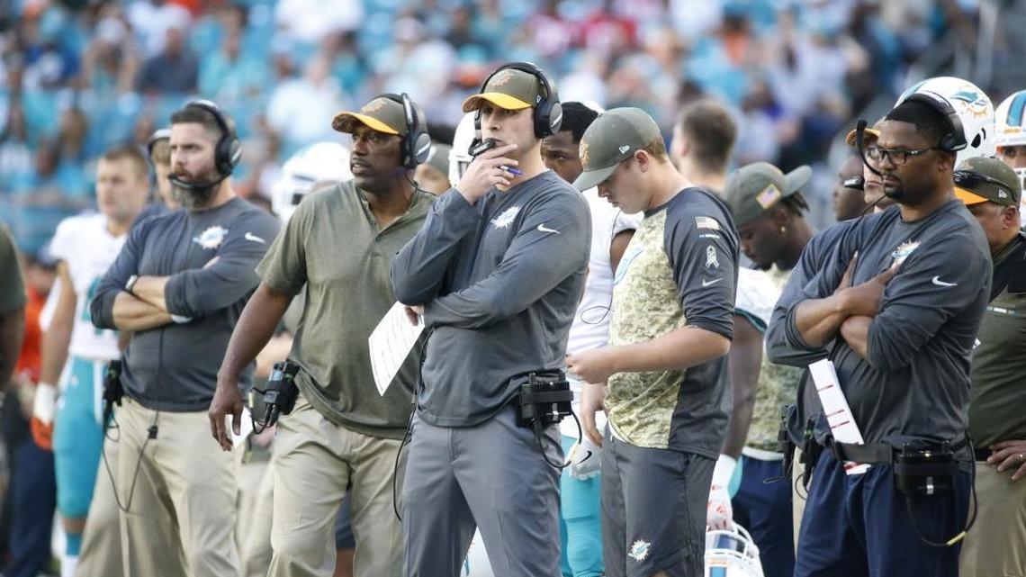 Miami Dolphins head coach Adam Gase and coaches look at the game from the sidelines, during the second half of an NFL football game against the Tampa Bay Buccaneers, Sunday, Nov. 19, 2017, in Miami Gardens, Fla.
