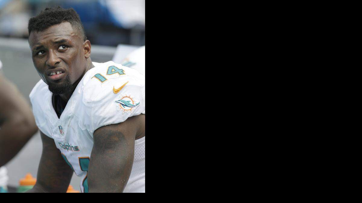 
Miami Dolphins wide receiver Jarvis Landry looks up from the bench during the second half of an NFL football game against the New England Patriots, Sunday, Sept. 7, 2014 in Miami Gardens, Fla. The Dolphins defeated the Patriots 33-20. 
