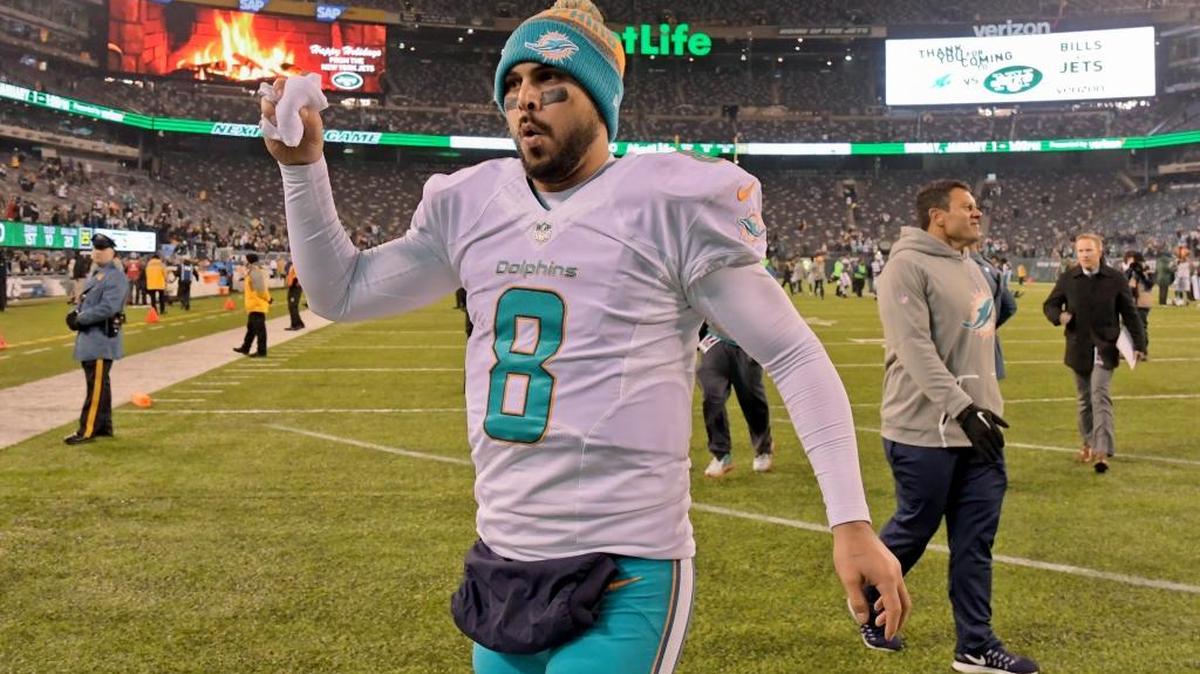 Miami quarterback Matt Moore leaves the field after leading the Dolphins to a 34-13 win over the Jets on Saturday night.
