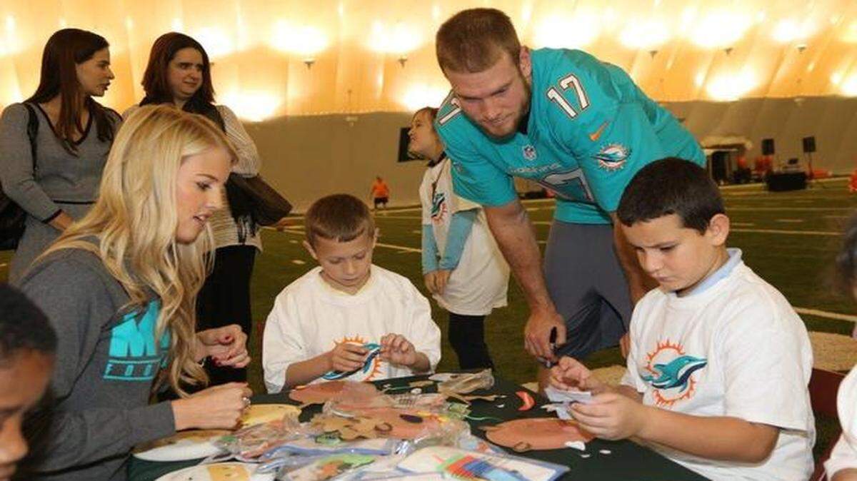 <cutline_leadin>Holiday cheer: </cutline_leadin>Quarterback Ryan Tannehill and his wife, Lauren, do crafts with students at the Dolphins Holiday Toy Event in Davie on Monday.