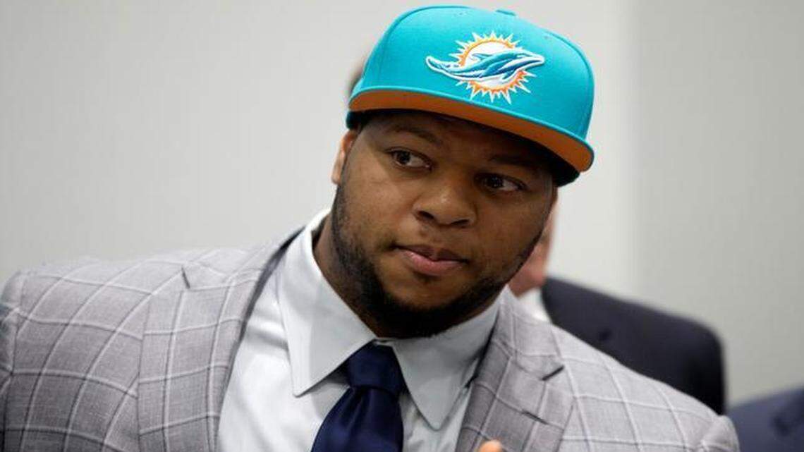 
Miami Dolphins' Ndamukong Suh wears a Dolphins cap during an NFL football news conference in Davie, Fla., Wednesday, March 11, 2015. Suh signed a $114 million, six-year deal with the Dolphins on Wednesday.
