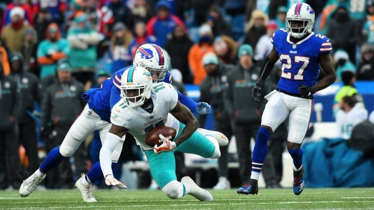 Miami Dolphins wide receiver DeVante Parker (11) catches a pass in front of Buffalo Bills free safety Jordan Poyer (21) and cornerback Tre'Davious White (27) during the second half of an NFL football game Sun., Dec. 17, 2017, in Orchard Park, N.Y. The Bills won 24-16.