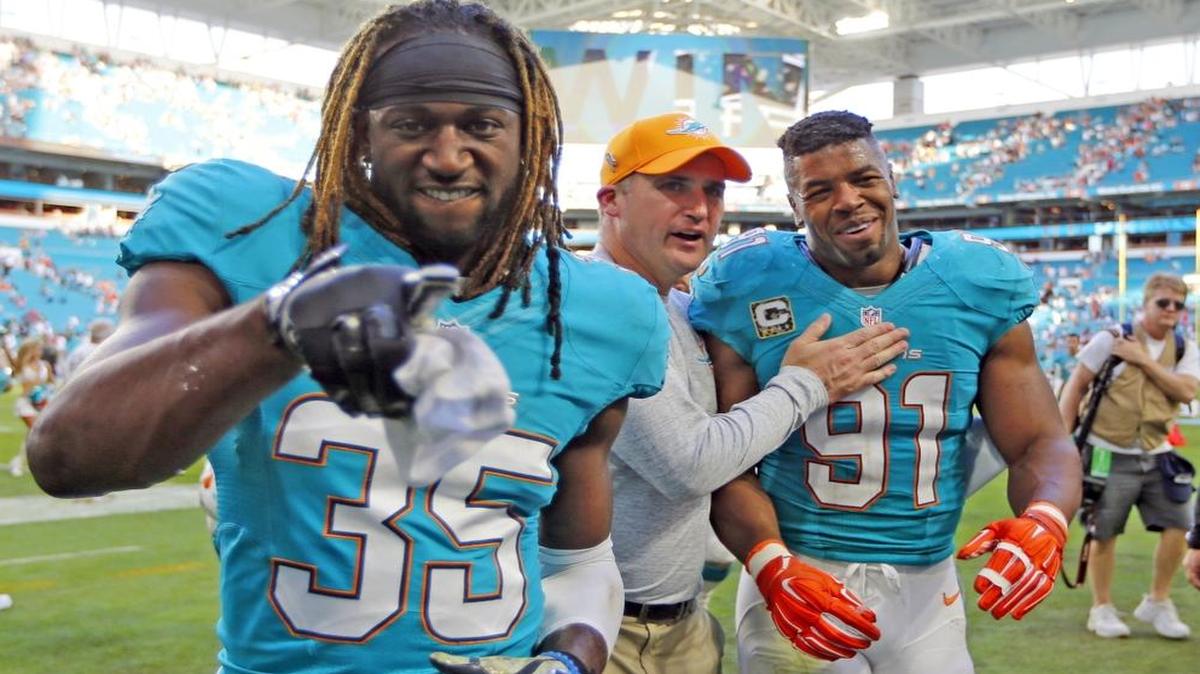 Miami Dolphins free safety Walt Aikens (35) and Miami defensive end Cameron Wake (91) walk of the field with special teams coordinator Darren Rizzi as the Miami Dolphins host the New York Jets at Hard Rock Stadium on Sun., Nov. 6, 2016.