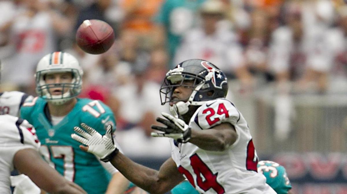 Quarterback Ryan Tannehill watches as conerback Johnathan Joseph bobbles and then intercepts his tipped pass in the second quarter of the game with the Miami Dolphins and Houston Texans at Reliant Stadium in Houston on Sept. 9, 2012.