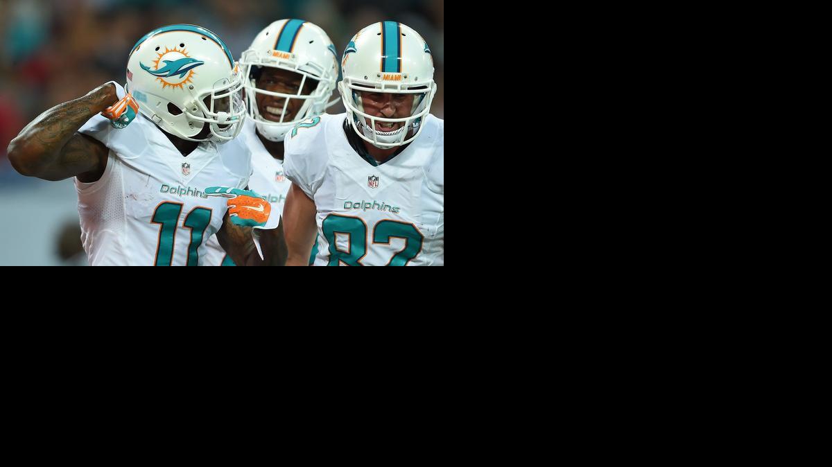 
Miami Dolphins' Mike Wallace, left, reacts after scoring a touchdown during the NFL football game against Oakland Raiders at Wembley Stadium in London, Sunday, Sept. 28, 2014. 
