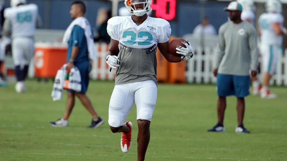 Miami running back Kenyan Drake runs drills during training camp in Davie on Aug. 1.