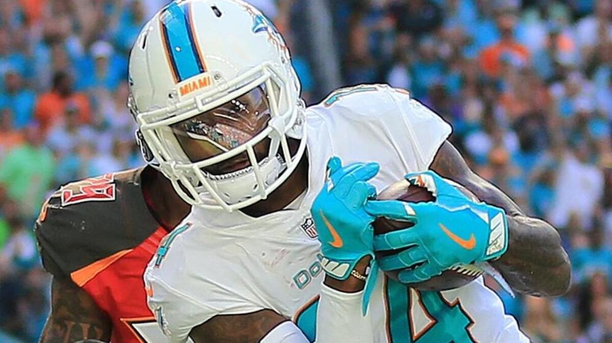 Miami Dolphins wide receiver Jarvis Landry (14) scores in the second quarter as Miami Dolphins strong safety Nate Allen (29) defends as the Miami Dolphins host the Tampa Bay Buccaneers at Hard Rock Stadium on Sun., Nov. 19, 2017.